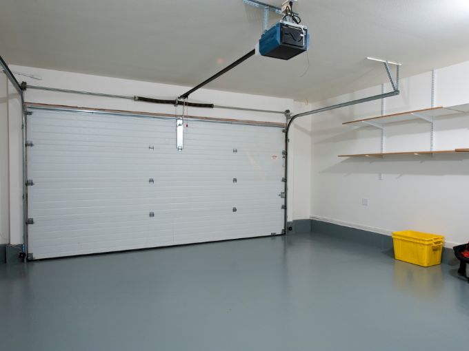 Reliable garage door opener system in a Greer home, showing the motor, tracks, and sectional door components.
