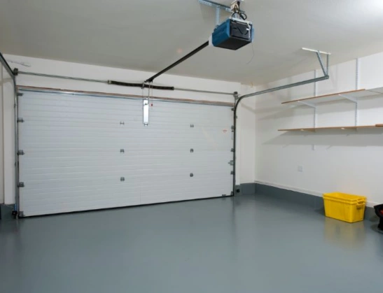 High-quality garage door track and torsion spring installation for a residential double-car garage door, featuring a ceiling-mounted opener.